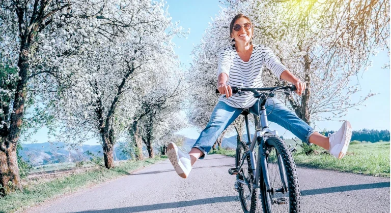 happy woman cycling spring reset